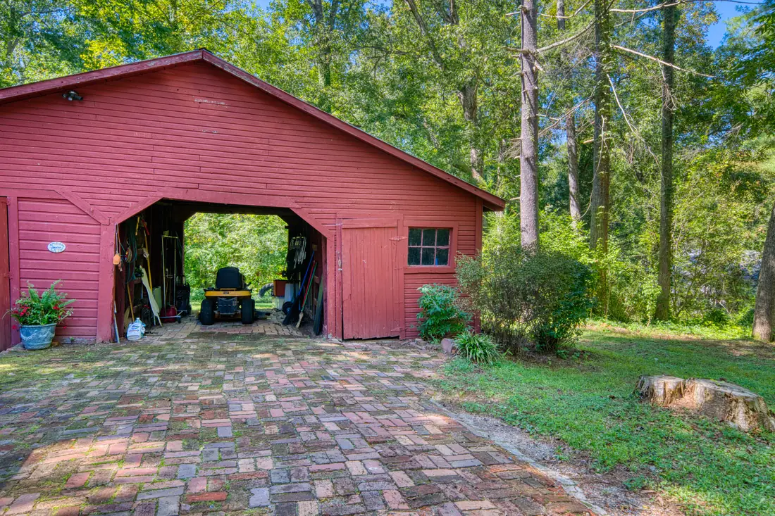 Red barn outbuilding with brick patio